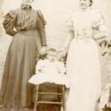 Lillie Bird Atkinson Hill, wife of Ambrose Hill, pictured at right. Also in picture Woman and Baby.  Florence Miriam Hill Morgan Photograph Album